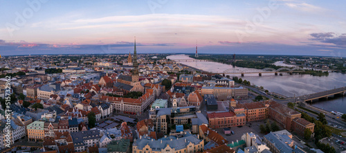 Cityscape of Riga Latvia with reflections on a quiet river. Aerial Riga v iew.