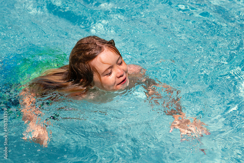 Child boy splashing in swimming pool. Active healthy lifestyle, swim water sport activity on summer vacation with children.