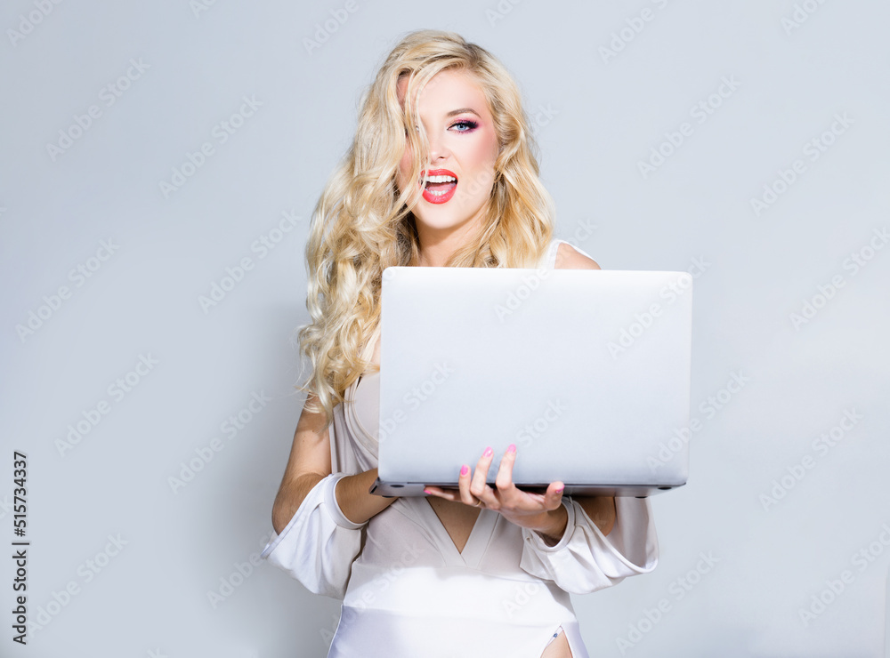 Naklejka premium Sexy secretary. Beauty blonde woman using laptop computer isolated background.