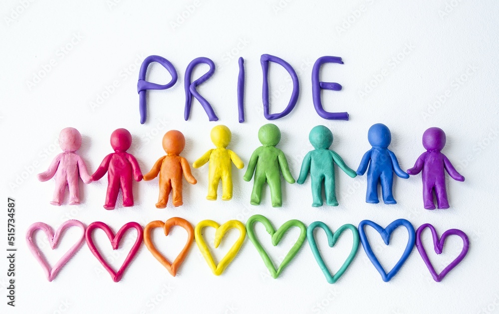 On a white background, the inscription pride multi-colored men and plasticine hearts, a symbol of love and unity.  Gay pride LGBT community, equal rights movement and gender equality life concept. 