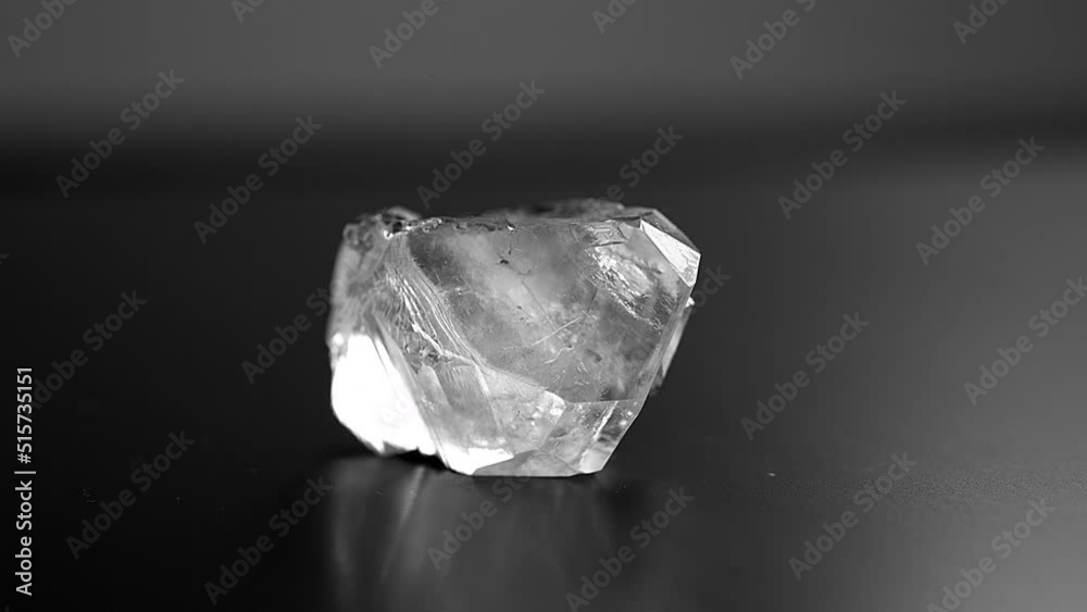 A precious rough stone for jewelry production rotates on an exhibition display