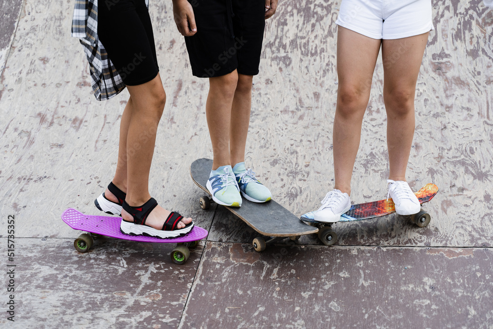 Kids friends with skateboard and penny boards on skate board park. Extreme lifestyle. Active children having fun together. Sports equipment. Kids friends with skateboard and penny boards on skate board park. Extreme lifestyle. Active children having fun together. Sports equipment.