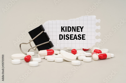 Among the tablets and capsules is a clip with paper on which is written - KIDNEY DISEASE photo