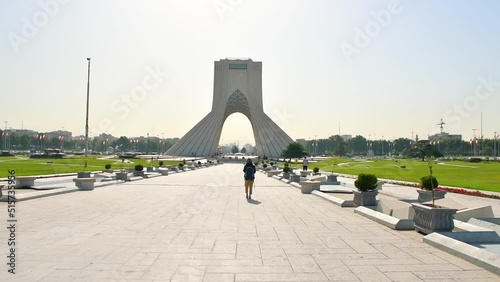 TEHRAN, IRAN JUNE 13, 2022: tourist walk by Azadi Tower , Freedom Tower formerly known as Shahyad tower photo