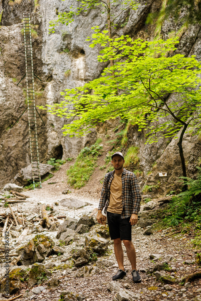Tourists go along the mountain route. Rocks and forest Tourists go along the mountain route. Rocks and forest