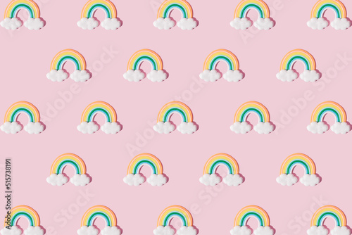 Small colorful rainbow cookie with clouds. Pattern. Pink background.