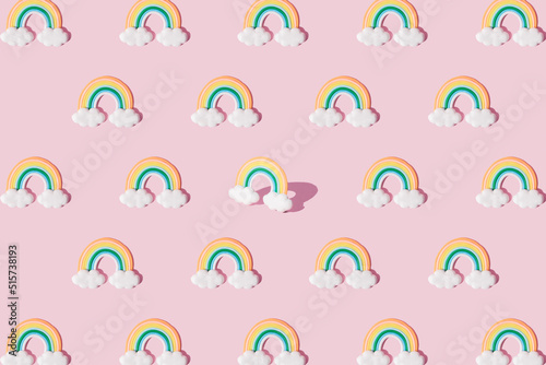 Small colorful rainbow with clouds. Pattern.