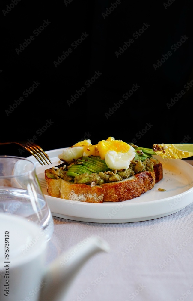 Avocado toast with poached egg. Cutting process. Avocado toast with poached egg. Cutting process.