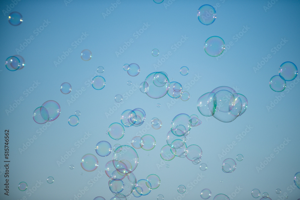 Giant colorful bubble. Big soap bubble on blue sky. Making huge rope soap bubbles.