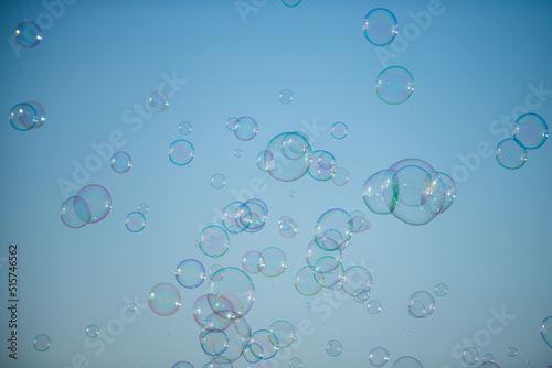 Giant colorful bubble. Big soap bubble on blue sky. Making huge rope soap bubbles.