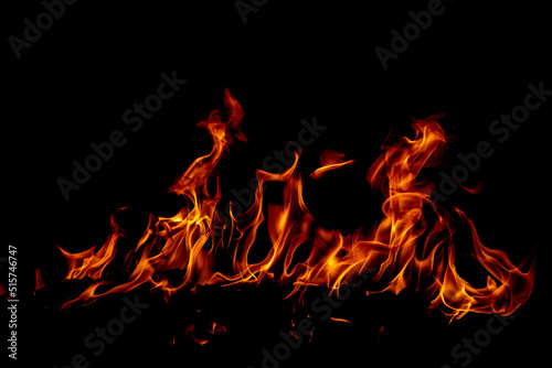 Fototapeta Fire flame. Burn lights on a black background.