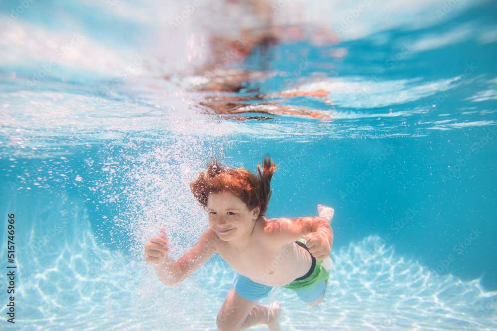 Children playing in swimming pool. Child swim under water in sea. Kid ...