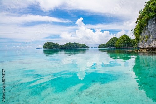 Calm Ocean and small islands, clouds and sky reflect on the water, Rock Island Southern Lagoon, Koror state, Palau