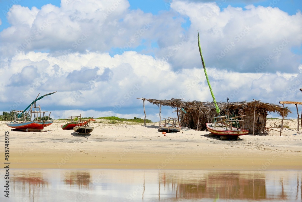 
Several boats parked on the beach. In the background the sea to the horizon line. A fisherman's hut on the beach. Cloudy sky;