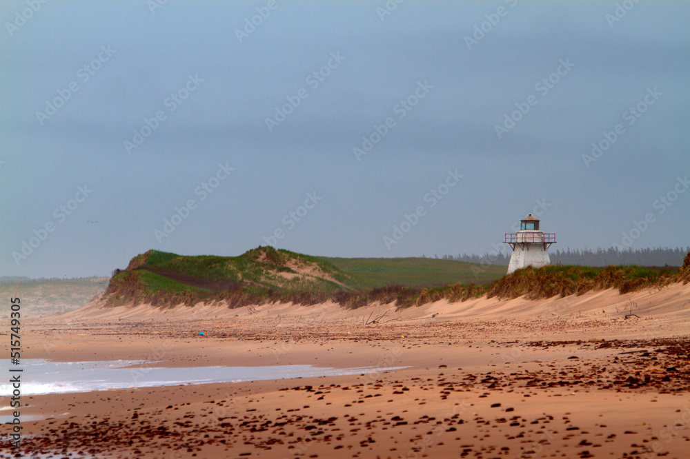 lighthouse with sand dunes on the beach