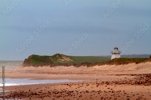 lighthouse with sand dunes on the beach