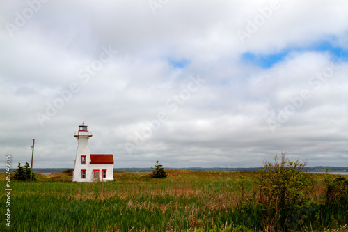 small lighthouse with big cloudy sky