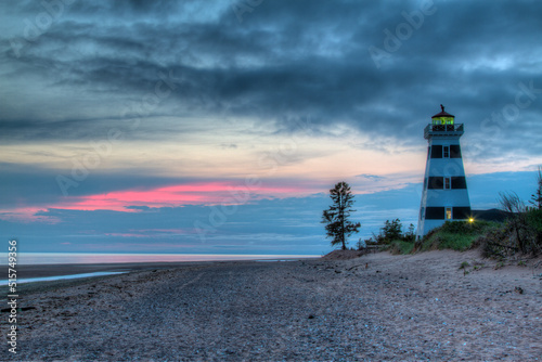 striped lighthouse on the beach