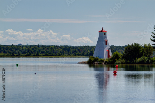 lighthouse with reflection on lake