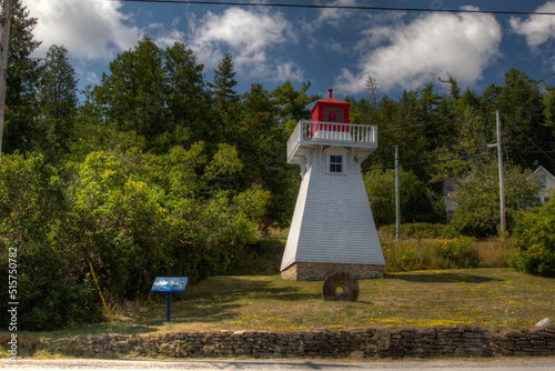 lighthouse with millstone and clouds
