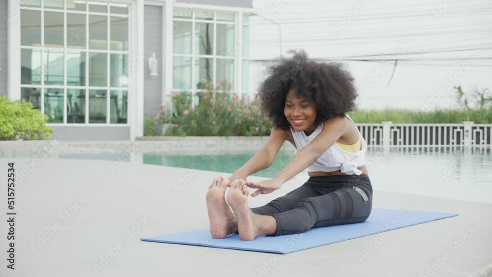 Young African American woman doing exercise with stretch muscles lag in the poolside, female training practicing workout with exercise for bodycare in the swimming pool, flexible of body. Young African American woman doing exercise with stretch muscles lag in the poolside, female training practicing workout with exercise for bodycare in the swimming pool, flexible of body.