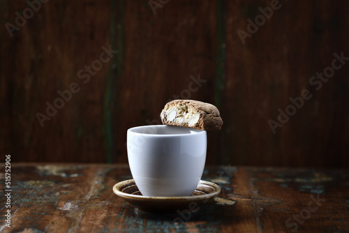 Cantuccini (Italian cookie) and a Cup of coffee on dark wooden background. Copy space