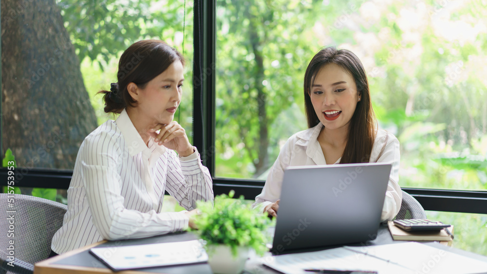 Coworker business concept, Two businesswoman look report on laptop to discussing project together Coworker business concept, Two businesswoman look report on laptop to discussing project together