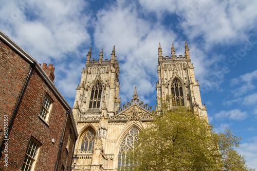 Cityscape exterior front view of the gothic style Cathedral and Metropolitical Church of Saint Peter, commonly known as York Minster, in the city of York, England