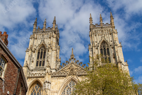 Cityscape exterior front view of the gothic style Cathedral and Metropolitical Church of Saint Peter, commonly known as York Minster, in the city of York, England photo