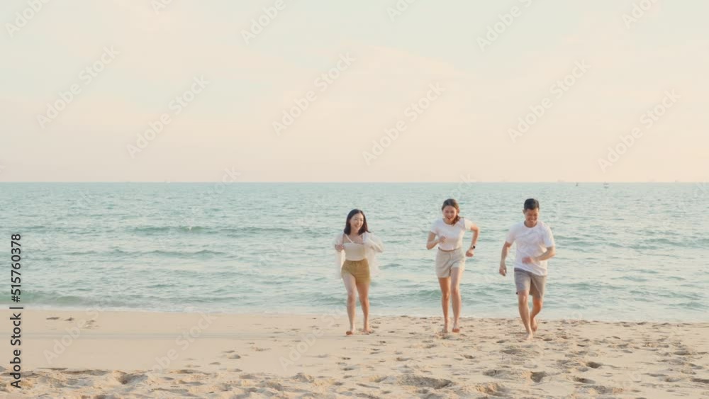 Happy friends holding hands running enjoy life funny freedom on sand at beach together from sea in holiday vacation time at sunset, Young Asian group woman and man in summer travel, people lifestyle Happy friends holding hands running enjoy life funny freedom on sand at beach together from sea in holiday vacation time at sunset, Young Asian group woman and man in summer travel, people lifestyle