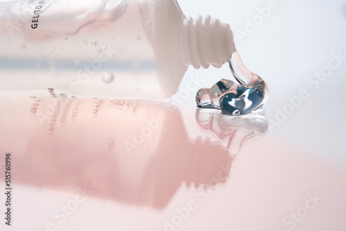 Hyaluronic gel or shower gel squeezed out of a bottle on a pink background.