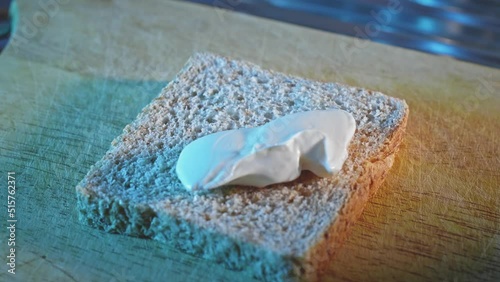 Spreading Low-Fat Cheese On Whole Grain Toast. close up