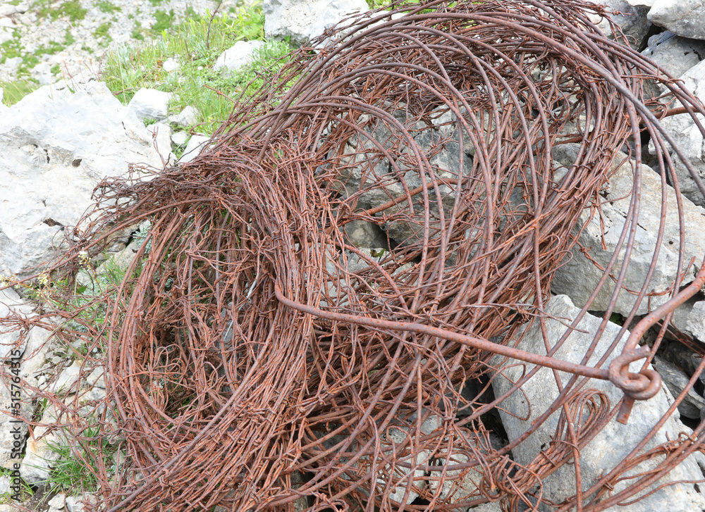 tangled skein of rusty barbed wire used to defend the borders during the first world war on the alps tangled skein of rusty barbed wire used to defend the borders during the first world war on the alps