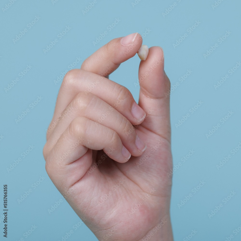 Child's hand holding first tooth milk, Dentistry and Health care concept Child's hand holding first tooth milk, Dentistry and Health care concept