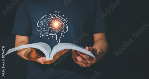 Reader man opens a book, finds new ideas with realistic brain icons, simulating new ideas. Ideas for reading, educating and creative. photo