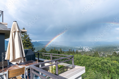 Rainbow over Fraser Valley, BC, after a flash rainstorm, as seen from a Burnaby Mountain rooftop patio.