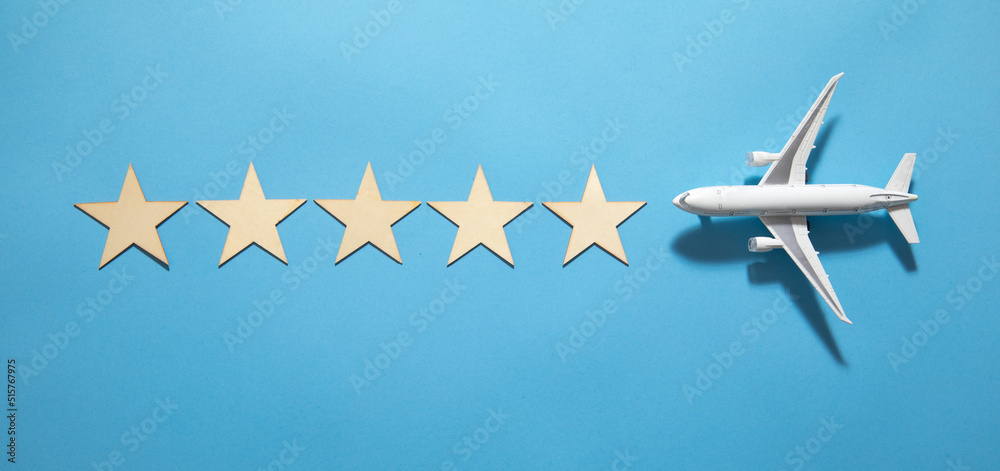 Naklejka premium Airplane with a 5 stars on the blue background.