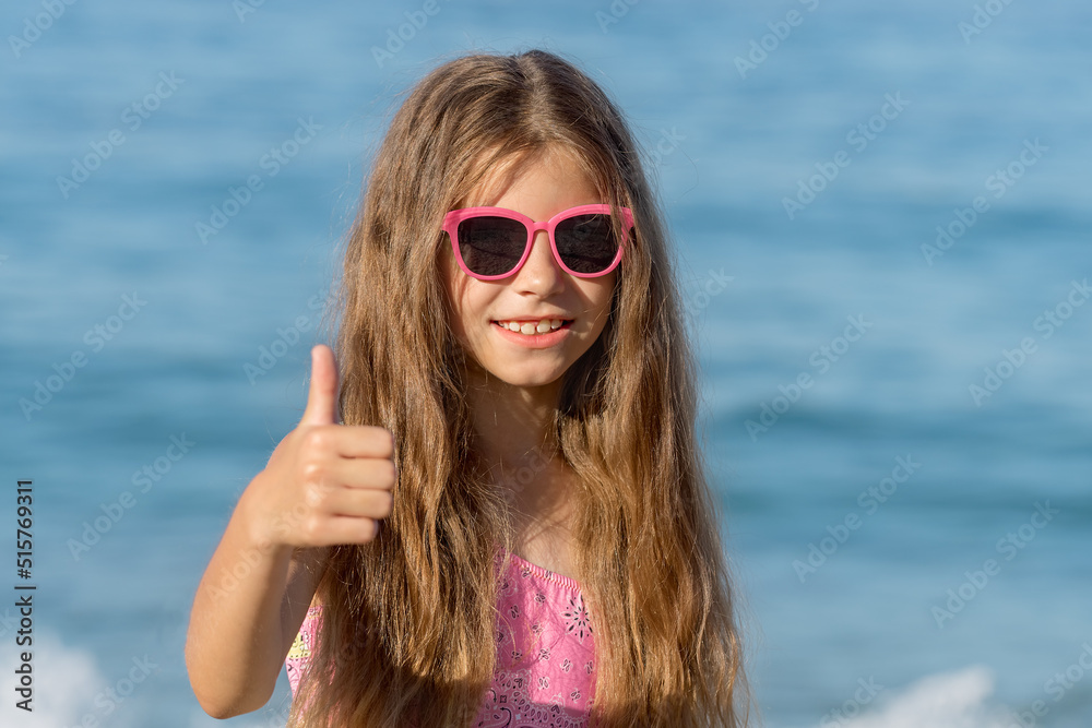 Close-up portrait of a girl in a bathing suit and glasses. Close-up portrait of a girl in a bathing suit and glasses.