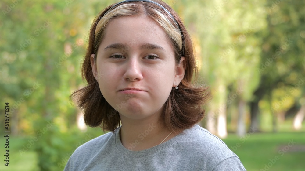 a teenage girl with an Asian appearance chews up leftovers and laughs with crumbs from her mouth. selective focus a teenage girl with an Asian appearance chews up leftovers and laughs with crumbs from her mouth. selective focus