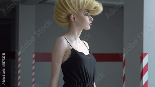 Modern young woman model posing on parking