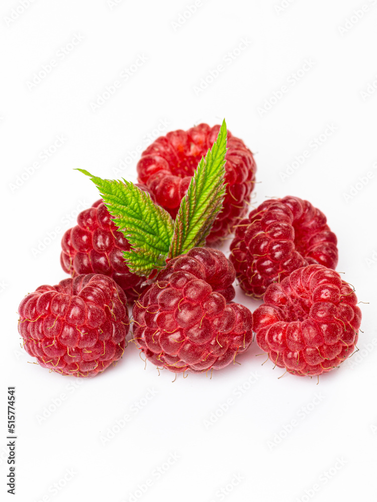 Isolated berries. Bunch of raspberry fruits with leaves isolated on white background with clipping path Isolated berries. Bunch of raspberry fruits with leaves isolated on white background with clipping path