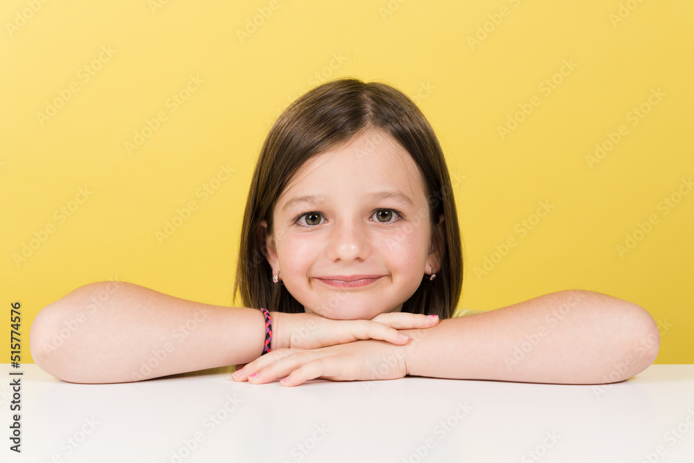 Portrait of cheerful little girl looking at camera isolated on yellow background. Portrait of cheerful little girl looking at camera isolated on yellow background.