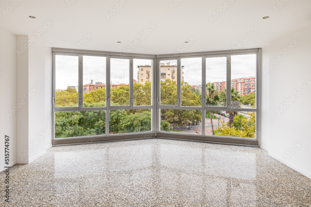 Fototapeta premium Empty interior with big panoramic window and view of cityscape in Barcelona, Spain