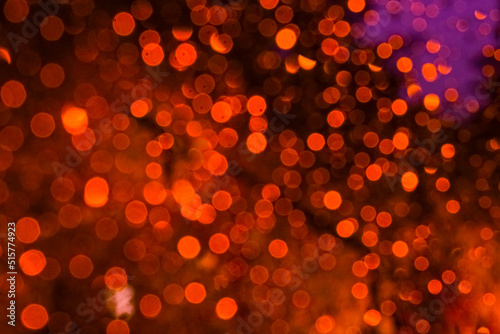 Orange-burgundy highlights, abstract bokeh, red background.