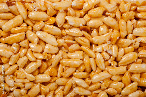 Sweetness from grains of puffed rice, shot close-up on a white background.