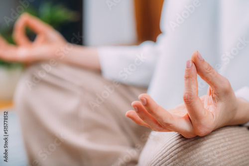 Peaceful Woman Meditating  Sitting in Lotus Position.
