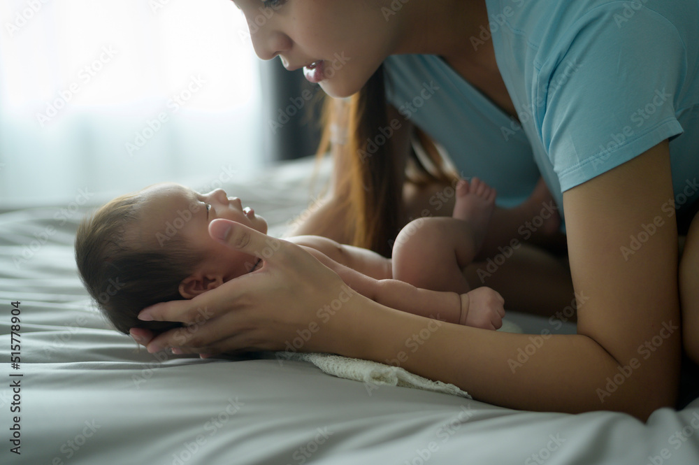 Young mother with a Cute new born baby.