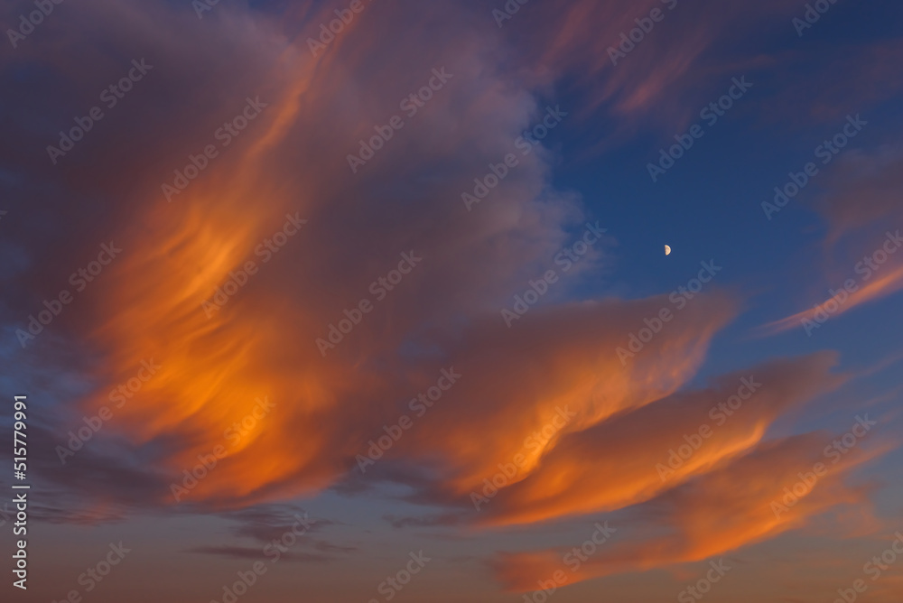 Sunset sky with large crescent moon, evening sky background