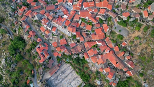 A shot from a drone over a stone village. View of the red roofs. Monsanto, Portugal