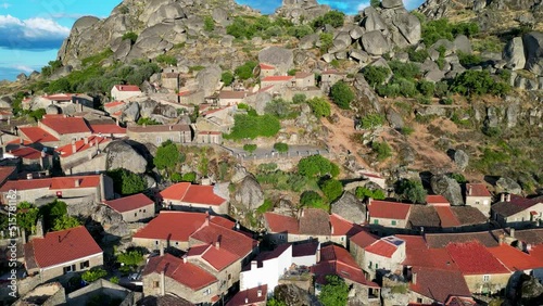Monsanto Portugal, Reverse drone flight. View of the stone village and the mountains. Huge stones in the background. The golden hour. 